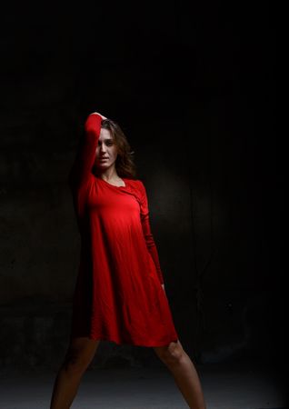 Young woman dancing in darkness