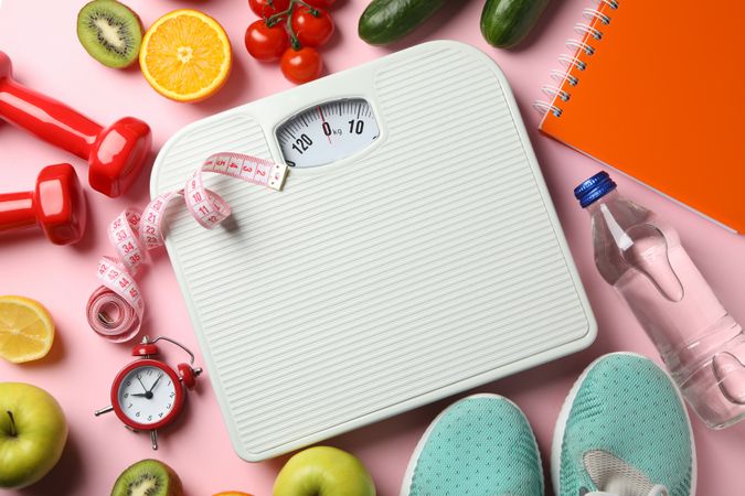 Weight loss or healthy lifestyle accessories on pink background