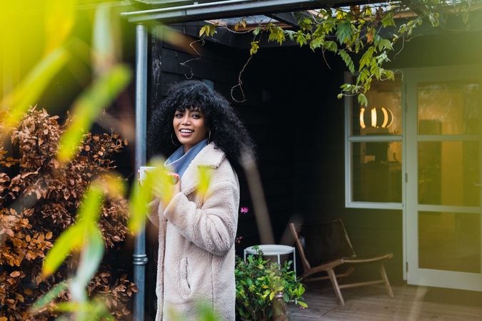 Smiling Black woman with cup of coffee