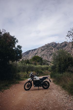 Motorcycle on remote road in the hills, portrait