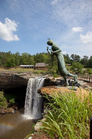 Waterfall and bronze Native American statue at a in Alabama