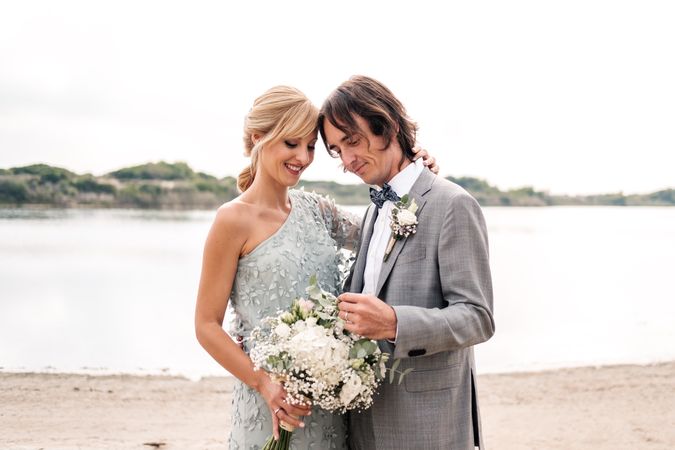 Happy young married couple spending time together at seaside