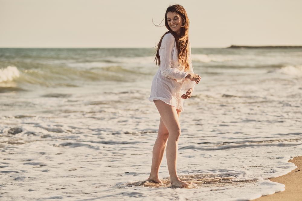 Woman with white dress at the beach