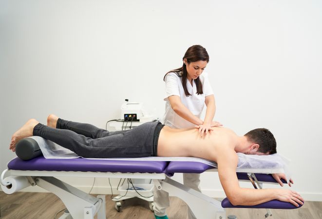 physiotherapist treating a contracture in the patient's back