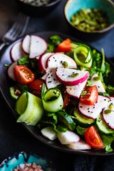 Close up of plate of healthy vegetable salad on rustic background