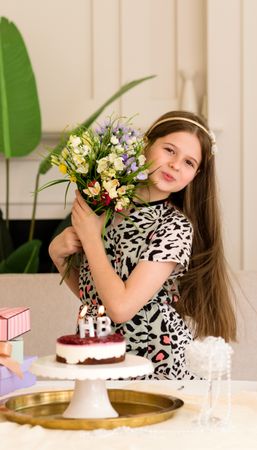 Smiling girl holding bouquet of flowers