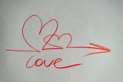 Valentine Day holiday card concept with love, hearts and arrow scribbled on paper