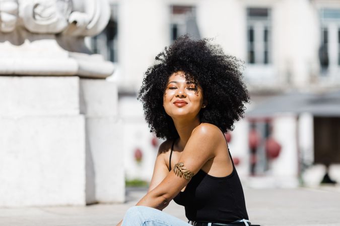 Black female siting on stairs outdoors