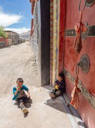 Tibet - August, 29 2014: Kids near monastery gate