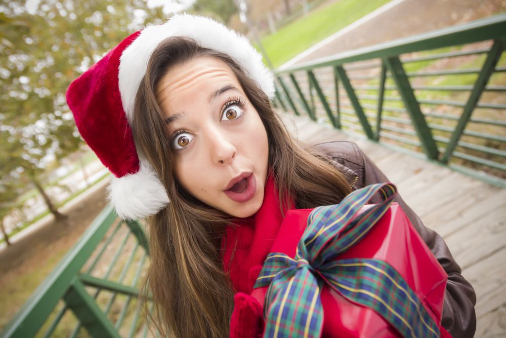 Woman a Christmas Hat with Wrapped Gift