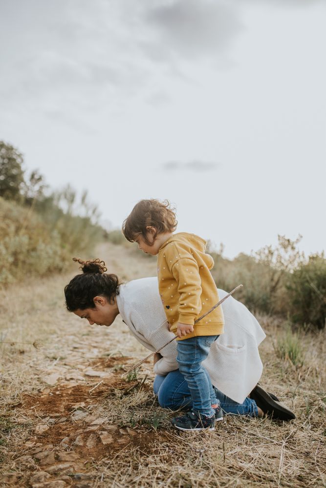 Mother and daughter looking at plants on a fall walk