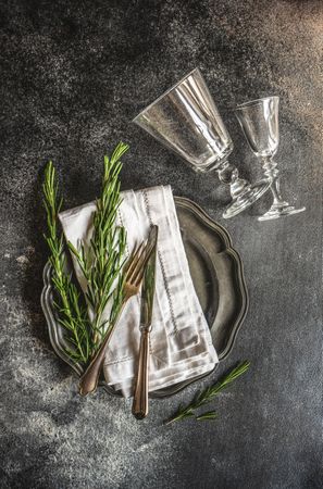 Table setting with fresh rosemary and glassware
