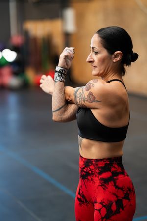 Fit woman warming up arms by stretching