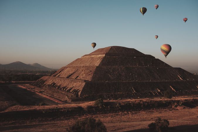 A few hot air balloons in flight over pyramids in Teotihuacan Valley, copy space