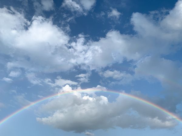 Full rainbow with clouds