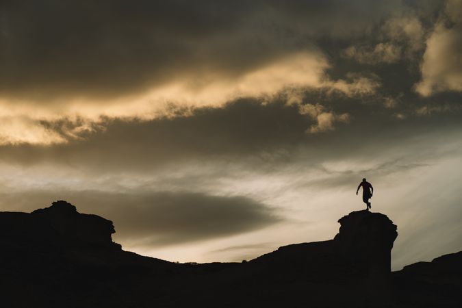 Man on mountain under beautiful sky