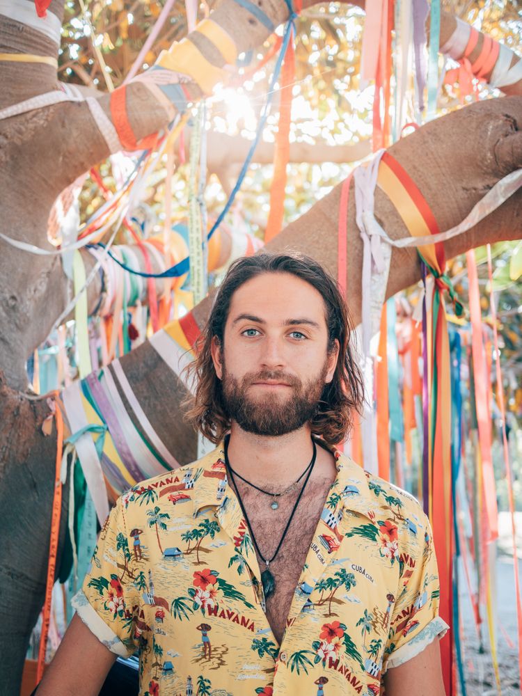 Hipster man walking in the jungle