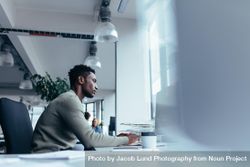 Side view of young Black man working in office 0Vjvj0