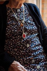 older woman with personal alarm hanging from the neck