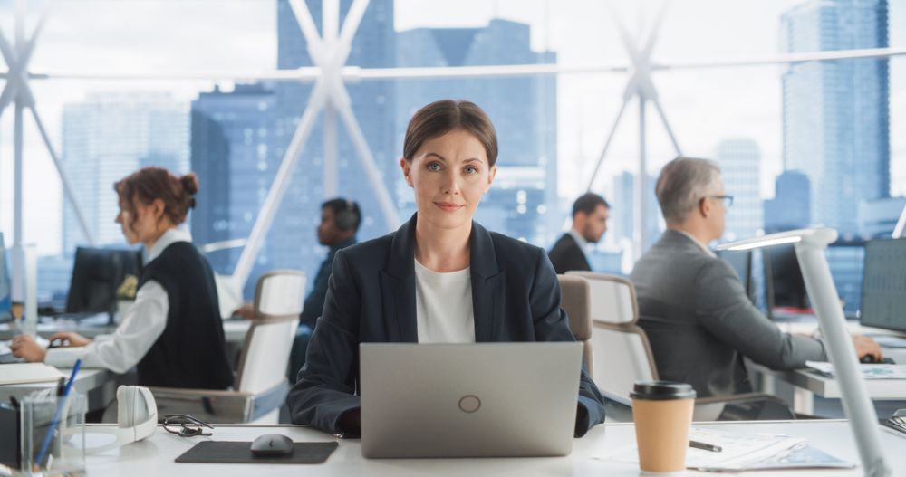 Professional Female Project Manager Typing On Laptop Computer In Skyscraper Office In Downtown.
