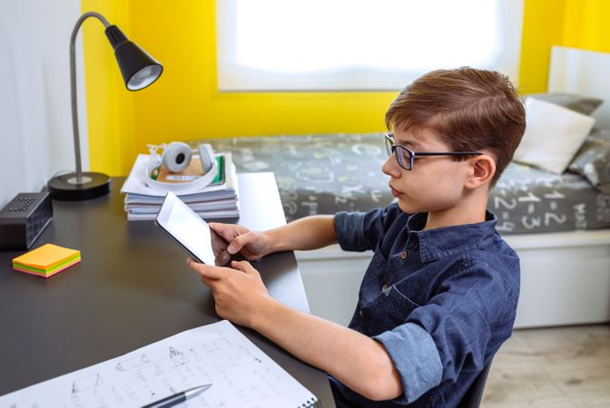 Boy doing homework with a tablet