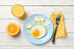 Egg in playful sky shape on blue plate