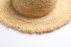 Pretty straw hat on plain background. Space for text, closeup
