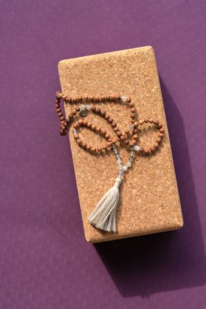 Rosary on yoga block on sports mat