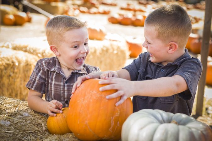 Two Boys at the Pumpkin Patch Talking and Having Fun.