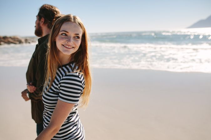 Woman walking on the beach with boyfriend