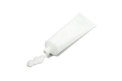 Blank tube with toothpaste isolated on light background