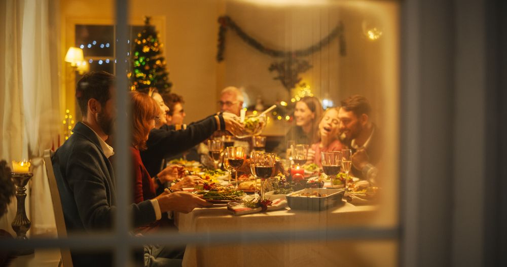 Happy Family Gather at Home for a Traditional Christmas Dinner with a Turkey Roast.