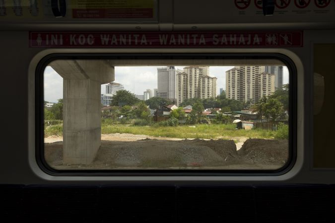 Exterior from inside one of the wagons of the KTM train line, in Kuala Lumpur, Malaysia