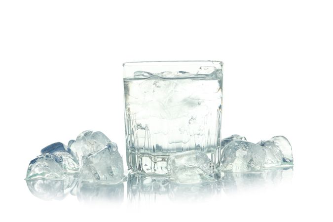 Crystal rocks glass full of water and surrounded by ice, copy space