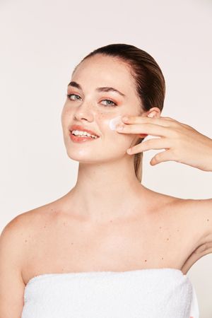 Amiable female taking care of face