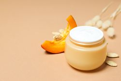 Skin care and face care concept - pumpkin cosmetic