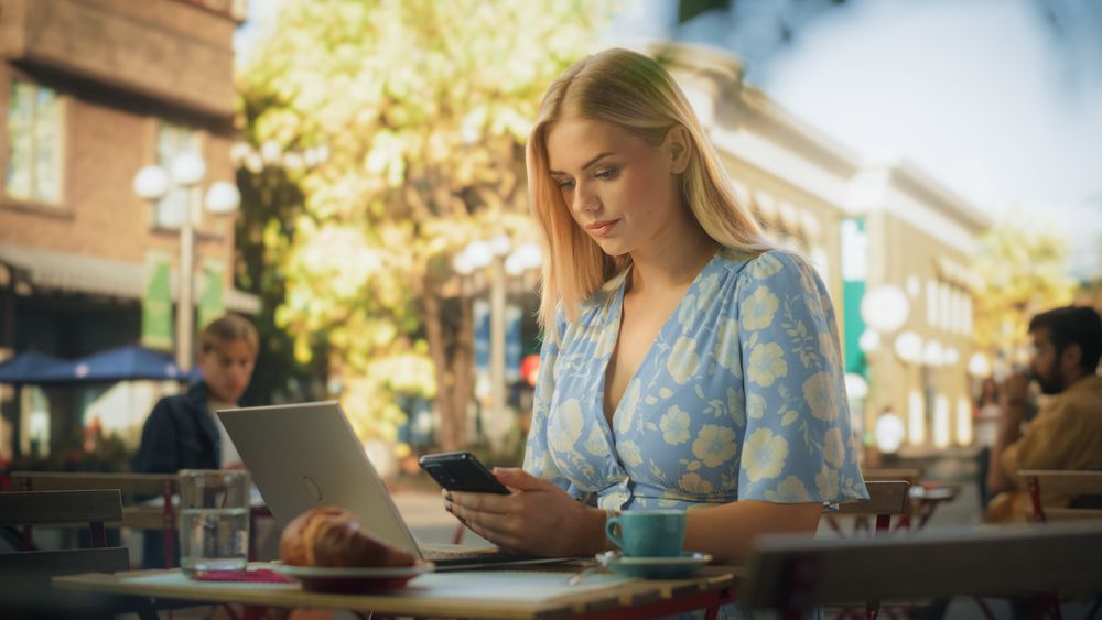 Remote Job Specialist Multitasking Company Management Assignments in an Outdoor City Cafe