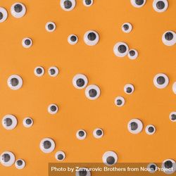 Variety of adhesive googly eyes on orange background 4OOdj4
