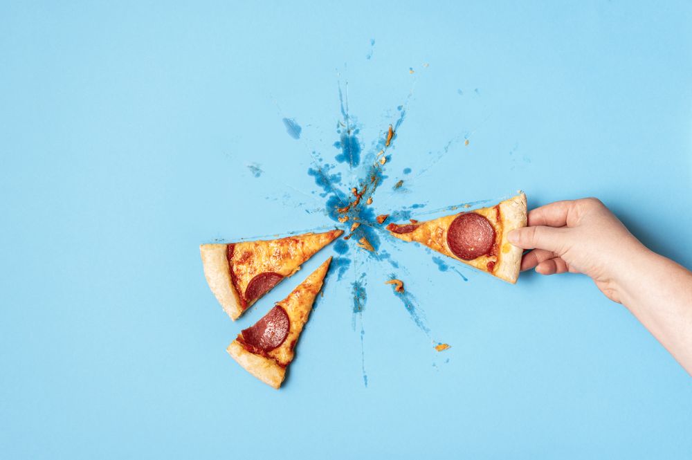 Grabbing slice of greasy pizza
