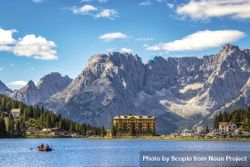 Two people on boat in lake Misurina in Parco Naturale Tre Cime in Italy 4dLQQ4