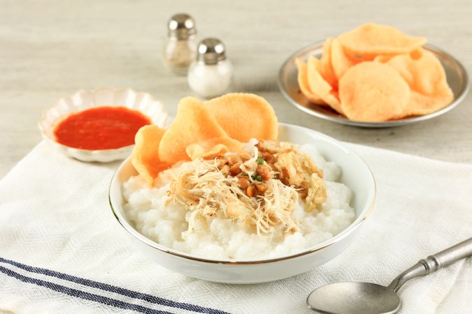 Close Up Bubur Ayam or Indonesia Chicken Porridge on White Bowl