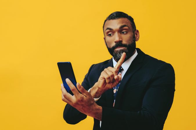 Agitated Black businessman having a video call on a smartphone screen