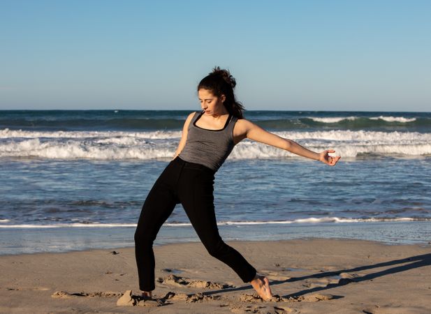 Woman with dancing near water on shore