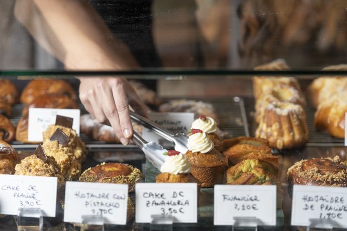 Assortment of delicious cakes on glass counter