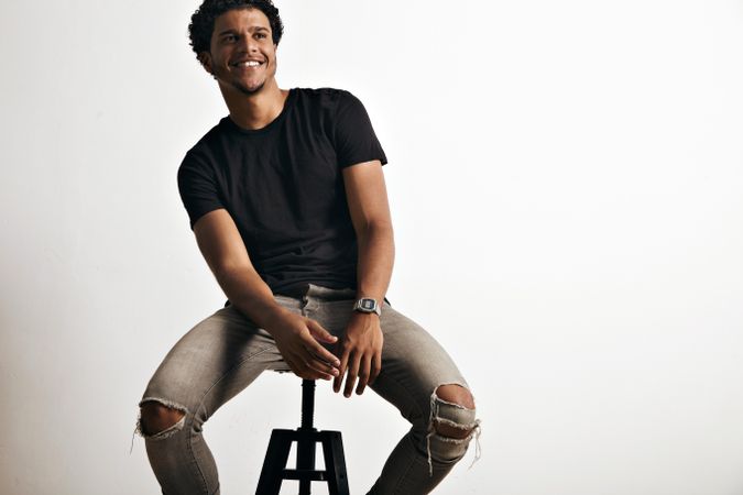Smiling man in dark clothes in studio shoot