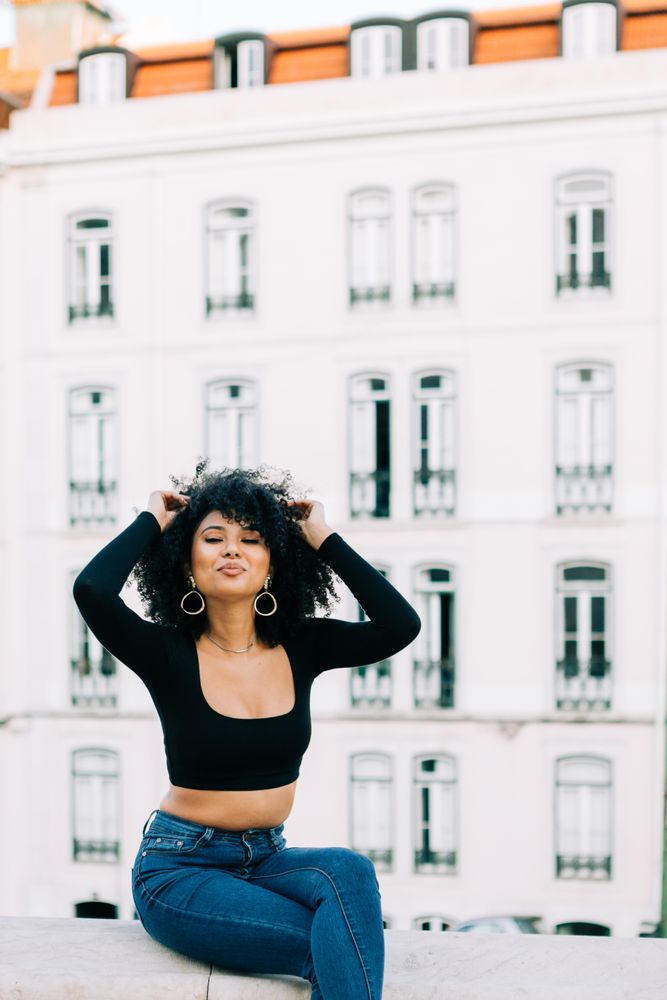 Fashionable Black female relaxing in city