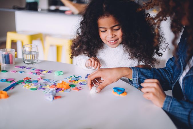 Mother and daughter playing with playdough