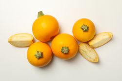 Round zucchini and slices on blank background, top view