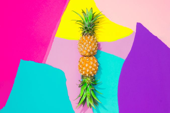 Pineapples on pattern of ripped paper in vivid colors