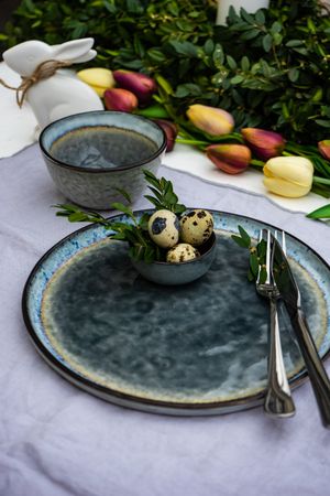 Festive table setting for Easter holiday dinner with speckled eggs